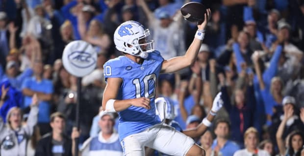 North Carolina Tar Heels quarterback Drake Maye celebrates a touchdown during a college football game.